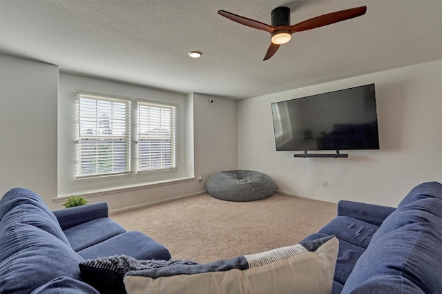 living room featuring a textured ceiling, carpet floors, and ceiling fan