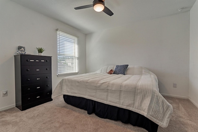 bedroom with ceiling fan and light colored carpet