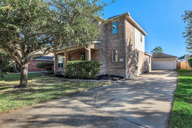 view of front of house featuring a front yard, a garage, and an outdoor structure