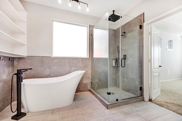 bathroom featuring shower with separate bathtub