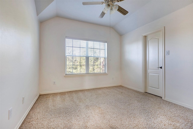 carpeted empty room featuring ceiling fan and vaulted ceiling