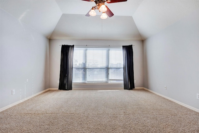 carpeted empty room featuring lofted ceiling and ceiling fan