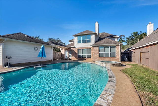 view of swimming pool featuring an in ground hot tub