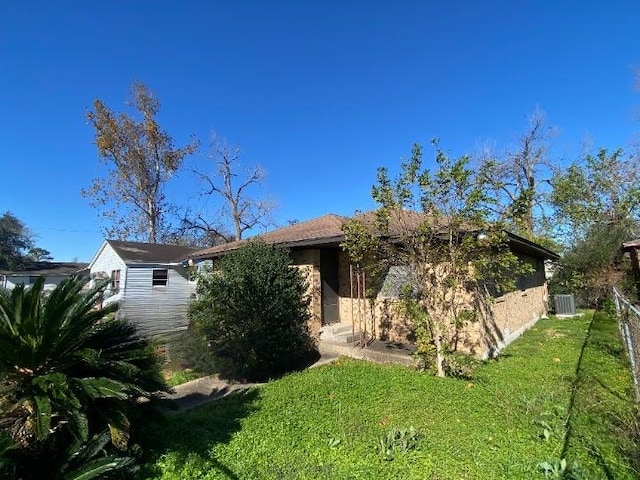 rear view of property with a yard