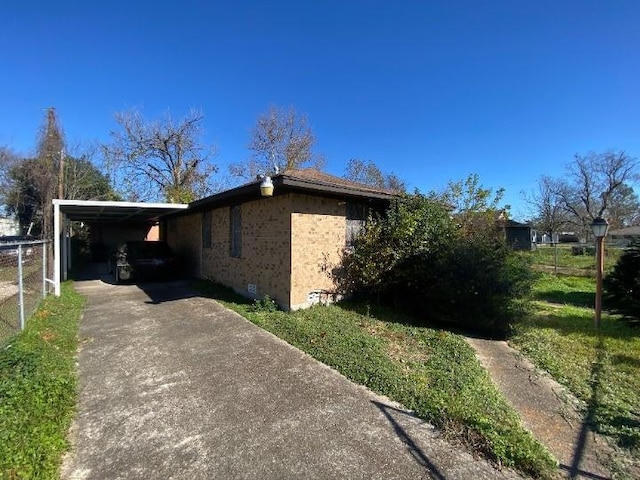 view of property exterior with a carport