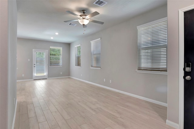 spare room with ceiling fan and light hardwood / wood-style flooring