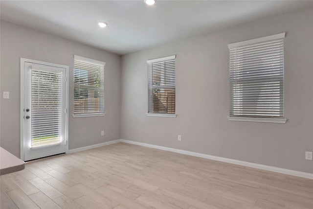 empty room with light hardwood / wood-style flooring