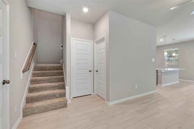 staircase with hardwood / wood-style floors