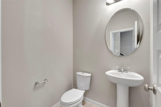 bathroom featuring toilet and sink