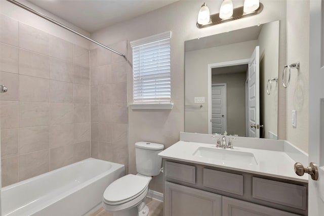 full bathroom with vanity, toilet, and tiled shower / bath