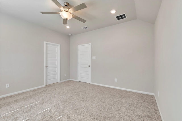 unfurnished room featuring vaulted ceiling, ceiling fan, and carpet floors