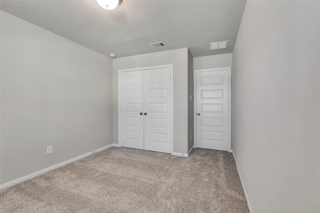 unfurnished bedroom featuring carpet flooring and a closet