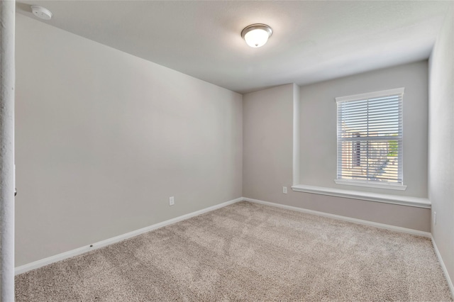 unfurnished room with light carpet