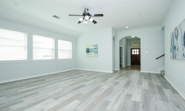 unfurnished room with ceiling fan, plenty of natural light, and light wood-type flooring