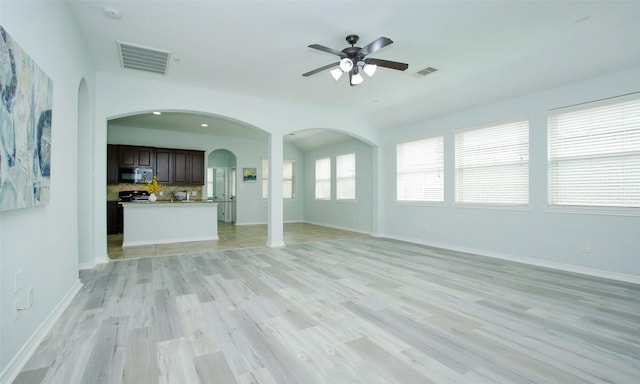 unfurnished living room featuring light wood-type flooring and ceiling fan