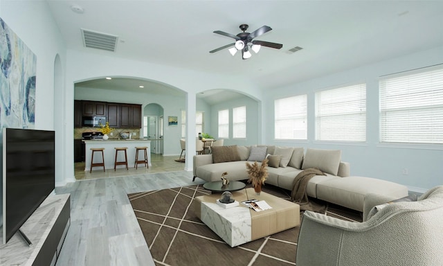 living room with ceiling fan and light hardwood / wood-style floors