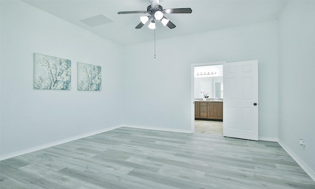 spare room with ceiling fan and light wood-type flooring