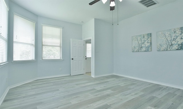 empty room with ceiling fan and light wood-type flooring