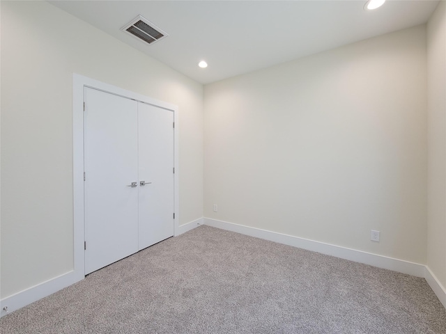 unfurnished bedroom with carpet flooring and a closet