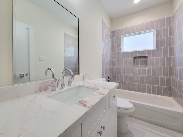 full bathroom with vanity, toilet, and tiled shower / bath