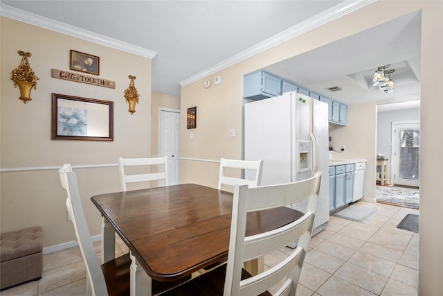 dining area featuring crown molding and light tile patterned floors