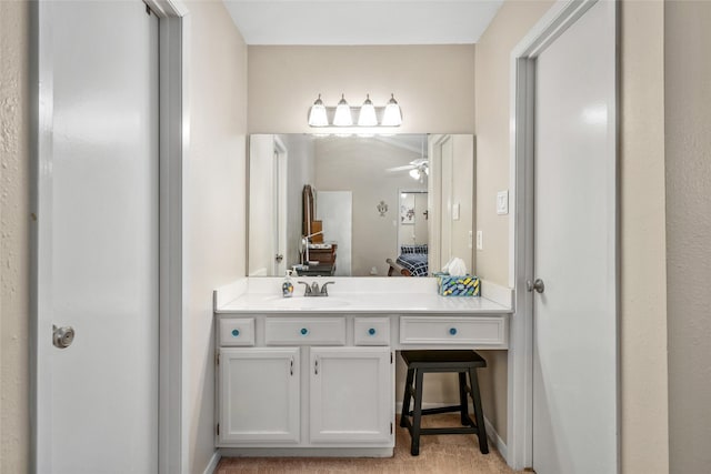 bathroom with ceiling fan and vanity