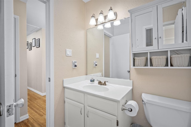 bathroom with hardwood / wood-style floors, vanity, and toilet