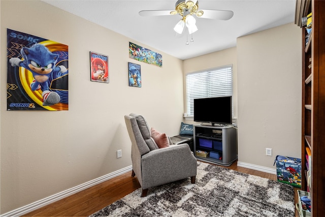 sitting room with hardwood / wood-style flooring and ceiling fan