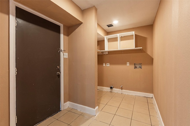 washroom featuring washer hookup, light tile patterned floors, and hookup for a gas dryer