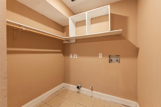 washroom with hookup for a gas dryer, hookup for a washing machine, and tile patterned flooring