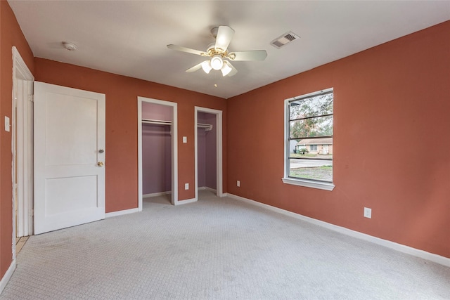 unfurnished bedroom featuring ceiling fan and light carpet