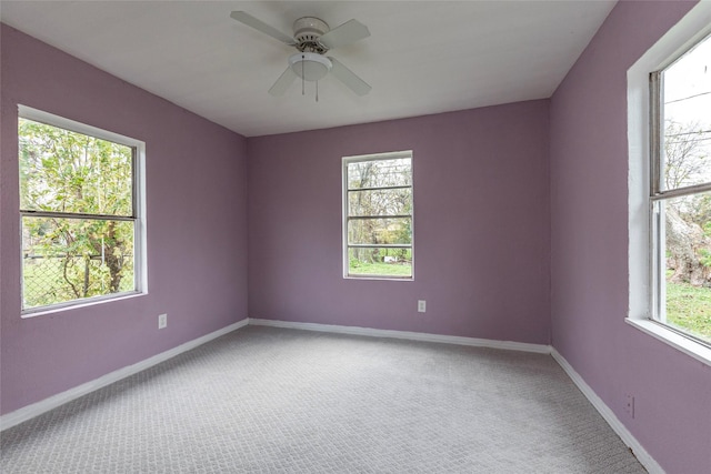 carpeted spare room with ceiling fan