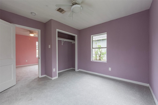 unfurnished bedroom featuring light carpet, a closet, and ceiling fan