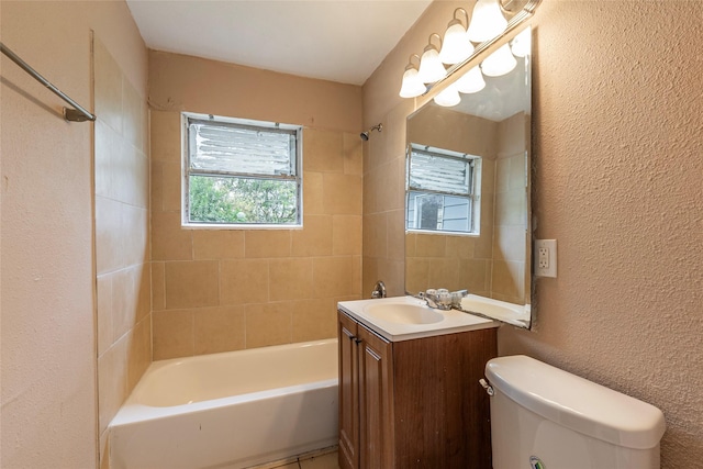 full bathroom with vanity, toilet, and tiled shower / bath combo