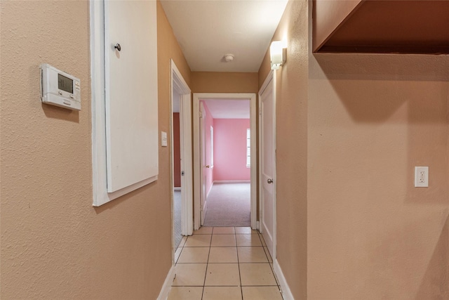 hall featuring light tile patterned flooring