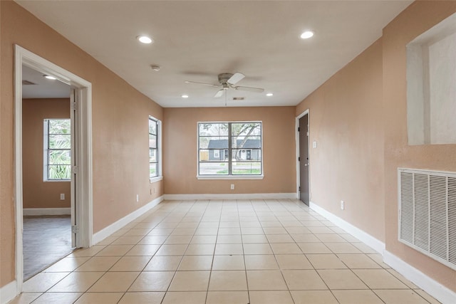 spare room featuring ceiling fan and light tile patterned flooring