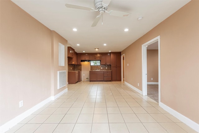 unfurnished living room with ceiling fan and light tile patterned floors