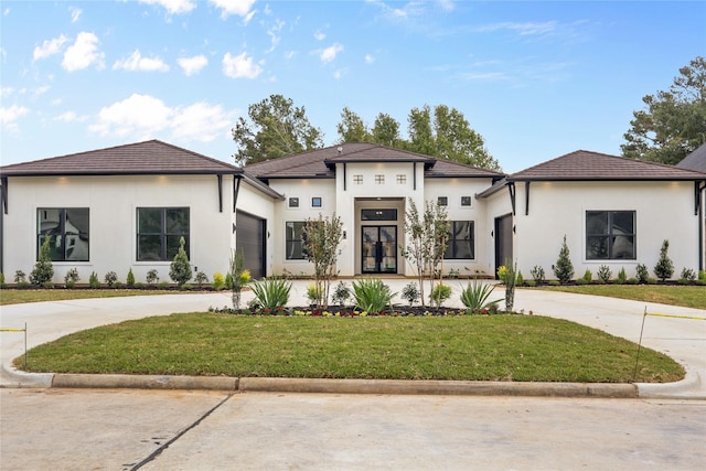 view of front of house with a garage and a front yard