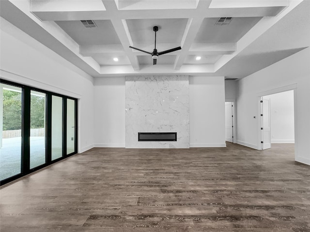 unfurnished living room featuring beam ceiling, ceiling fan, coffered ceiling, a premium fireplace, and dark hardwood / wood-style floors