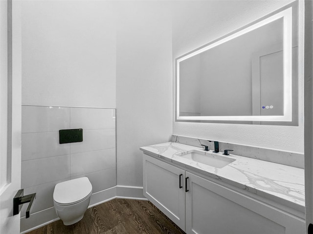 bathroom with vanity, toilet, and wood-type flooring