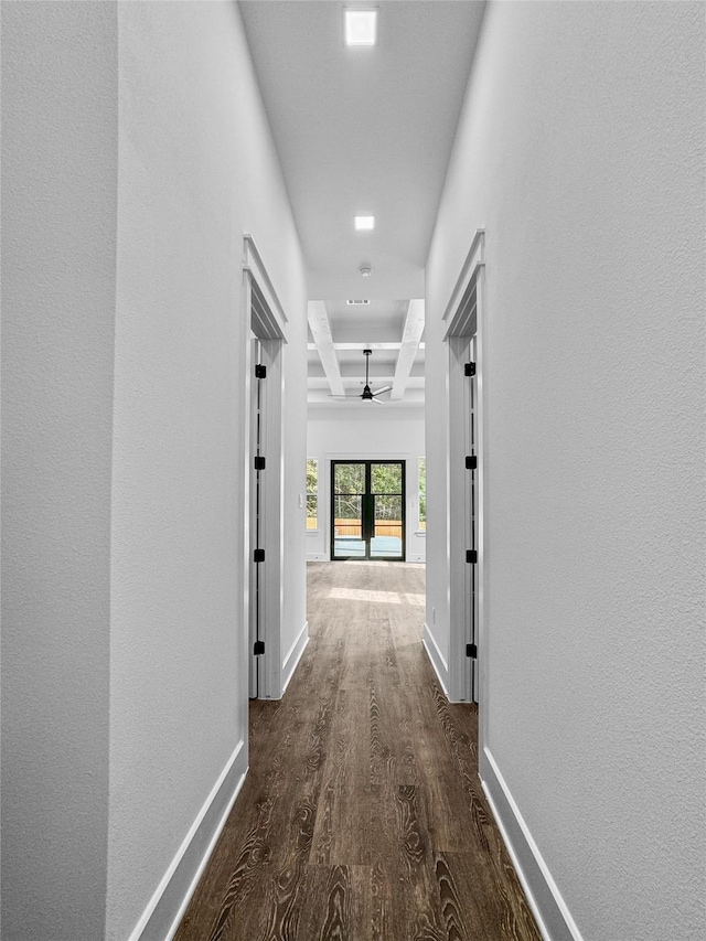 hallway with beam ceiling, dark hardwood / wood-style flooring, french doors, and coffered ceiling