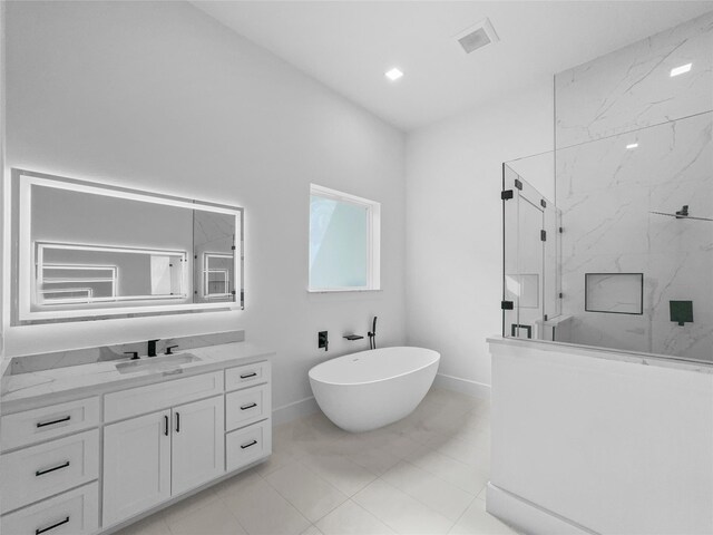 bathroom with vanity and independent shower and bath