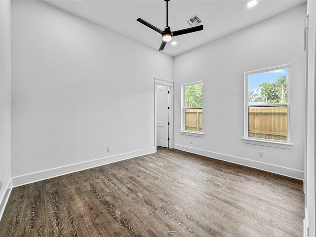 spare room featuring ceiling fan and dark wood-type flooring