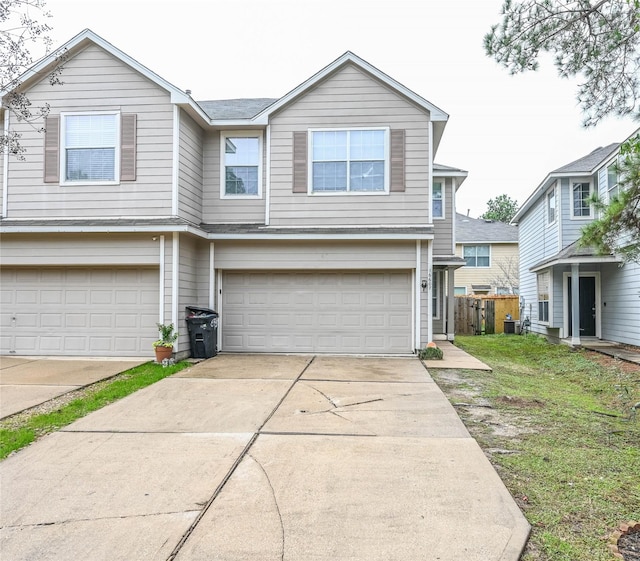 view of front of house with a garage and central AC