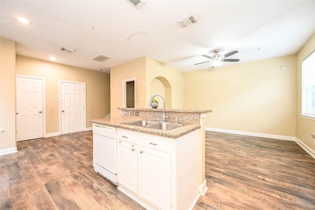 kitchen with dishwasher, white cabinets, a center island with sink, sink, and hardwood / wood-style flooring