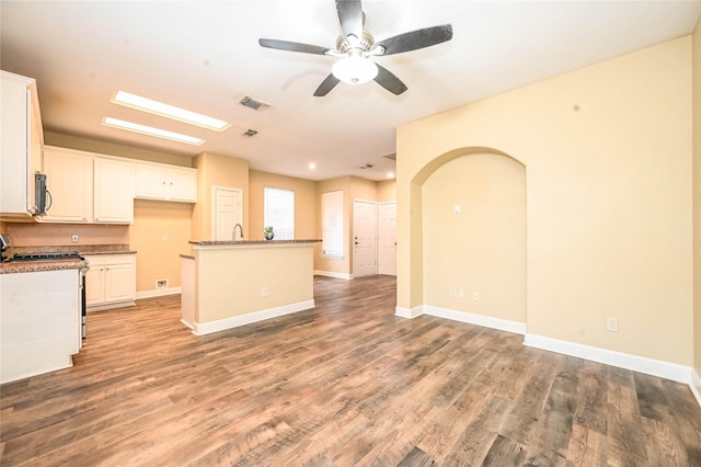 kitchen featuring white cabinets, white range, light hardwood / wood-style floors, and a kitchen island