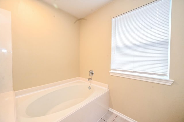 bathroom with tile patterned floors and a bathing tub