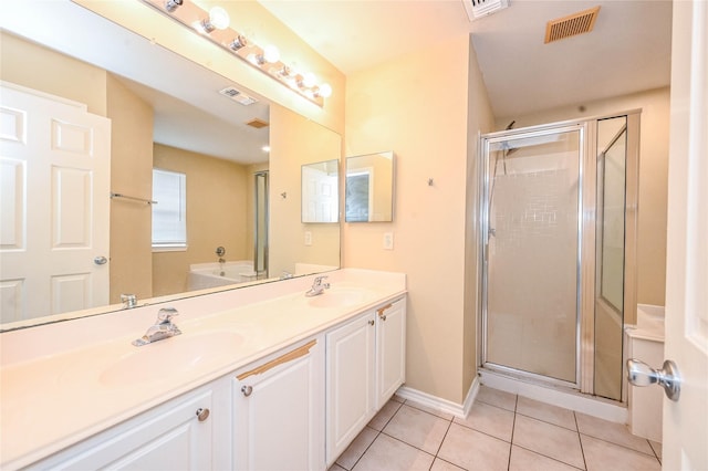 bathroom with tile patterned floors, vanity, and walk in shower