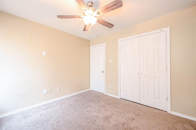 unfurnished bedroom featuring carpet flooring, a closet, and ceiling fan