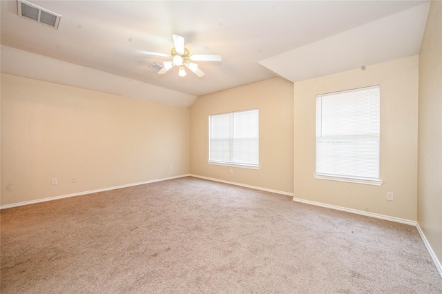 empty room with carpet flooring, ceiling fan, and lofted ceiling